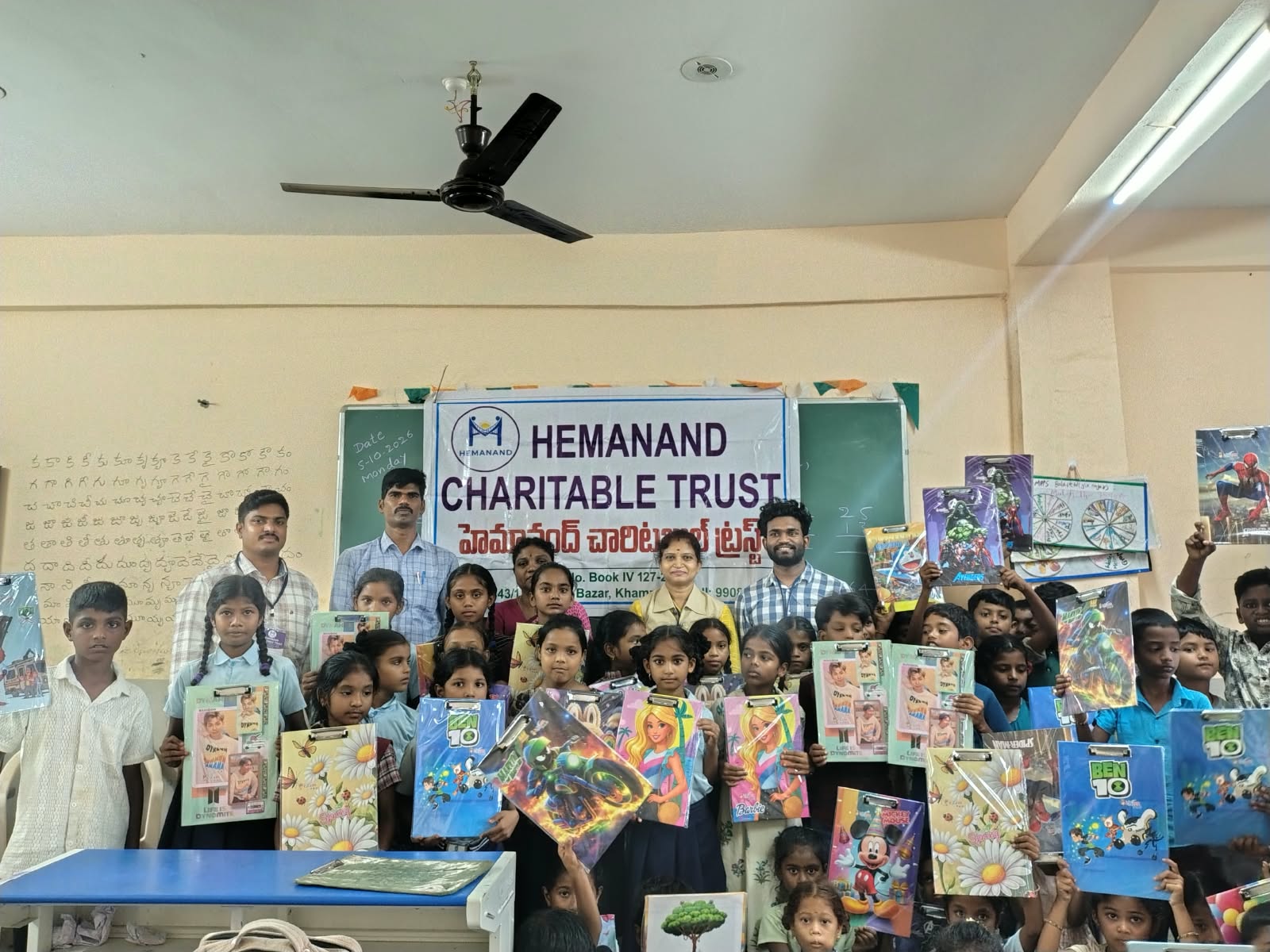 Hemanand Charitable Trust Distributes Exam Pads to Government School Students in Khammam